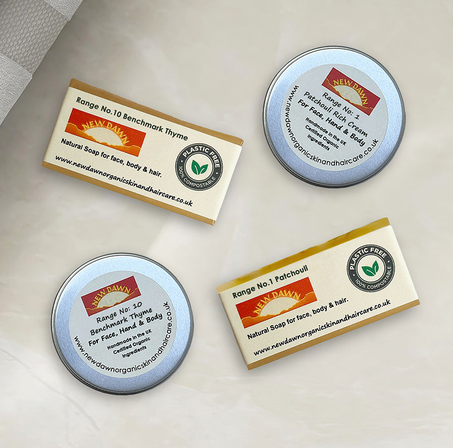 Two soaps and two tins of body cream on a table.