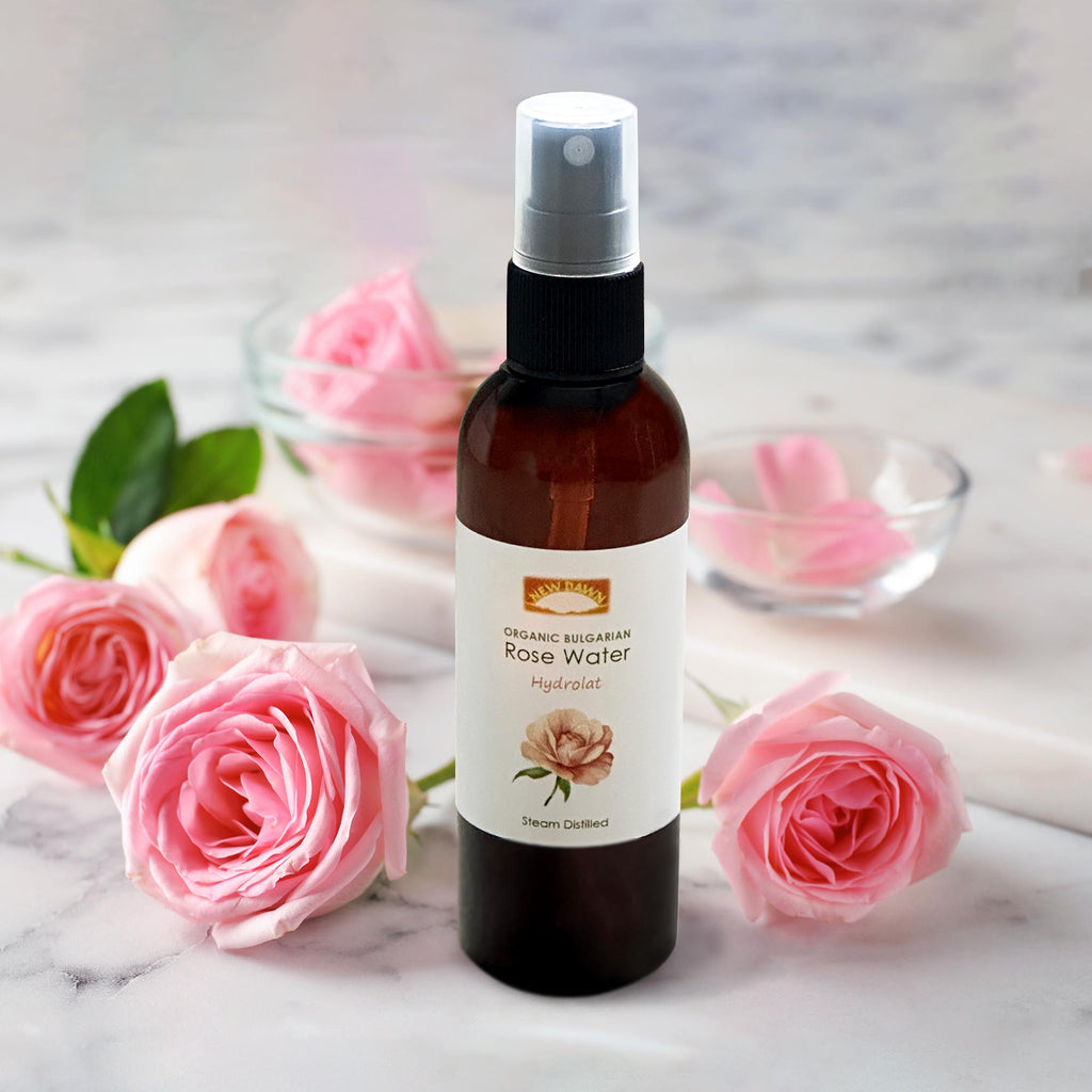 A bottle of organic Bulgarian rosewater surrounded by roses.